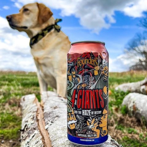A yellow lab in a field by a large can of 4 Giants and the Haze of Destiny.